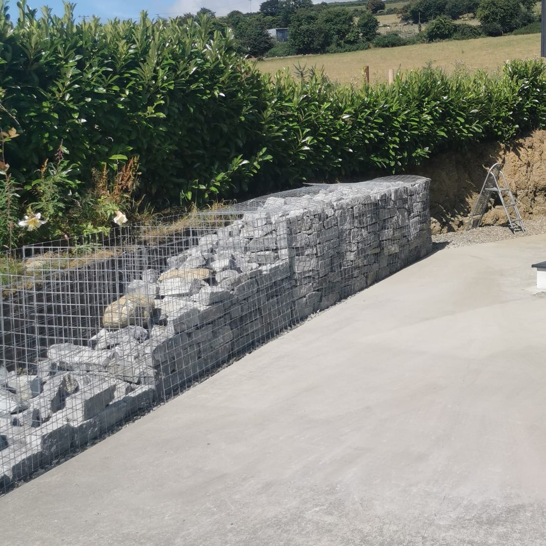 White limestone Gabion retaining wall under construction