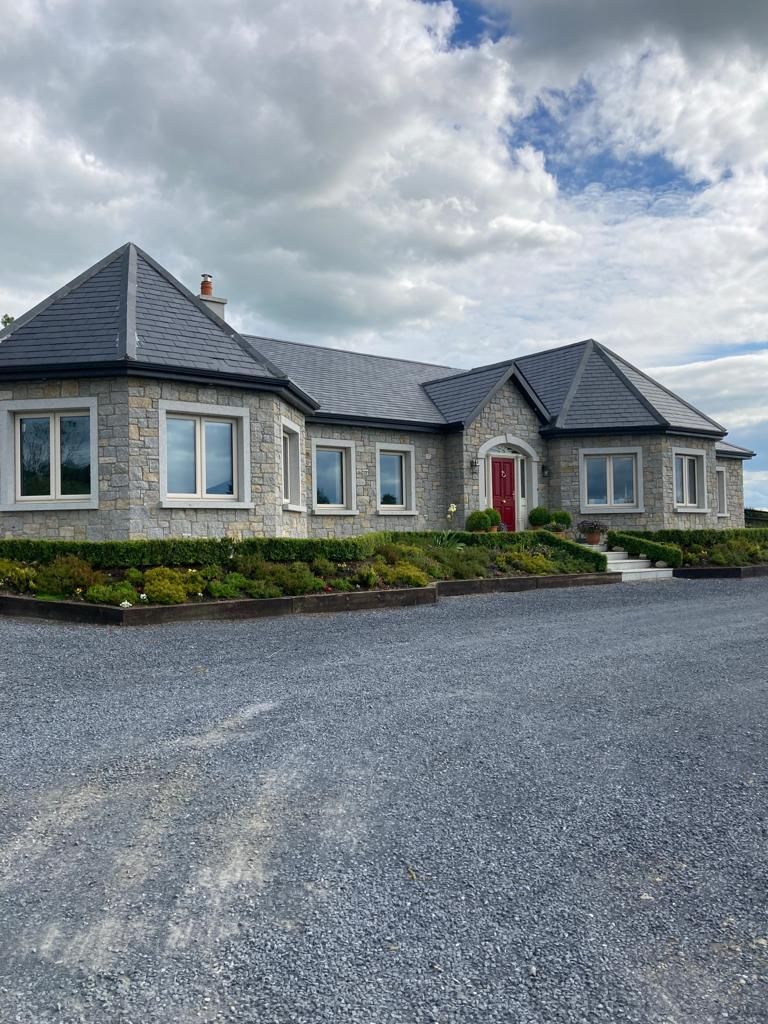 Grey & cream granite mixed with cut granite window & door surrounds