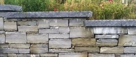 Dressed rock face complimenting a dry grey sandstone wall