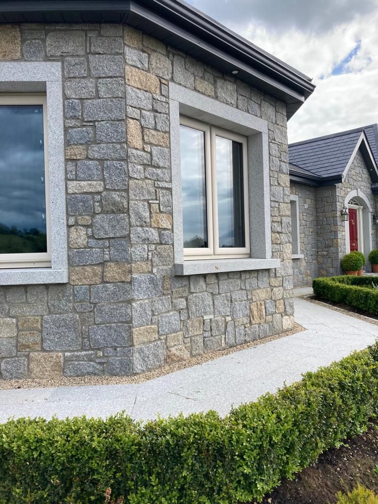Grey & cream granite mixed with cut granite window & door surrounds