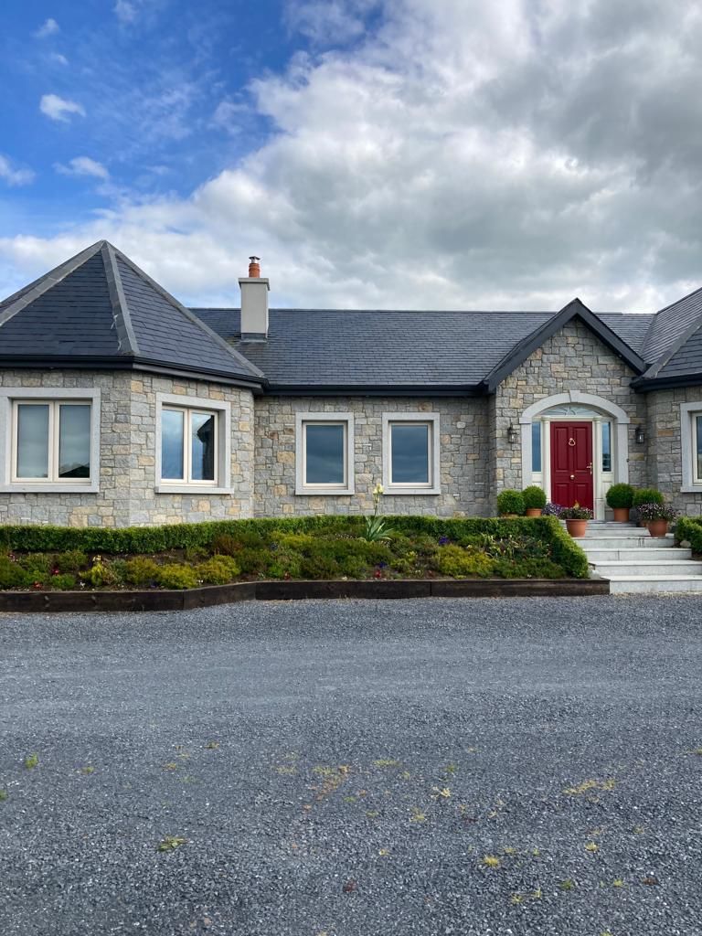 Grey & cream granite mixed with cut granite window & door surrounds