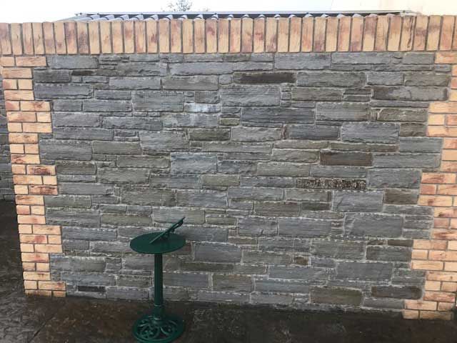 Dressed grey sandstone with brick surround