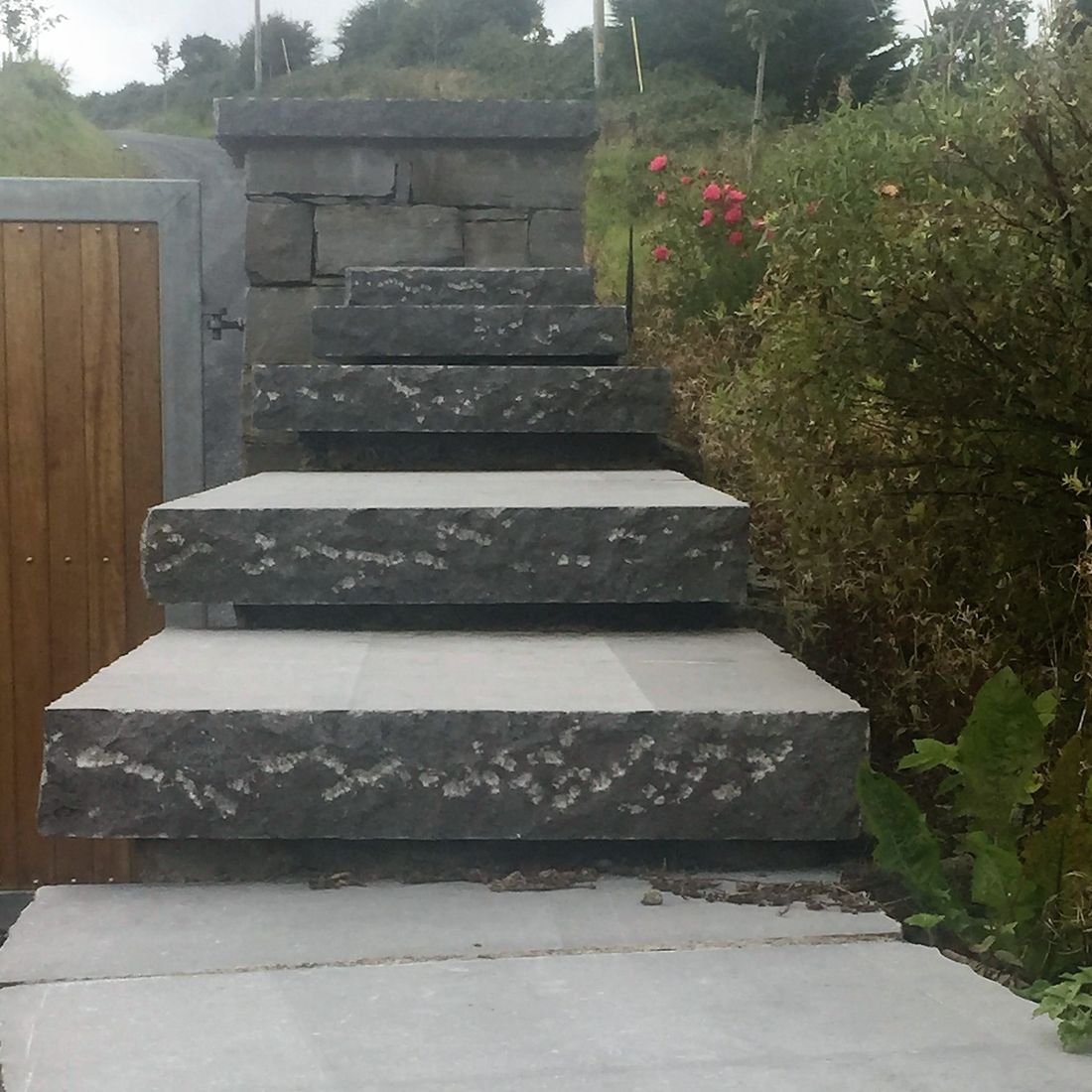 Stepped limestone pitched rock face capping