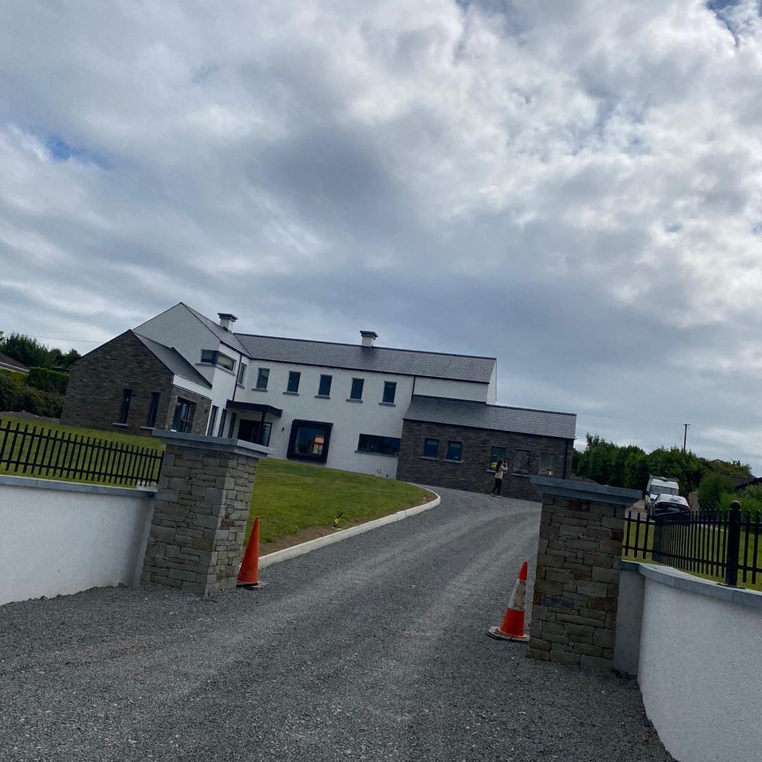 Sanded Irish limestone wall and pier caps enhancing a grey sandstone entrance