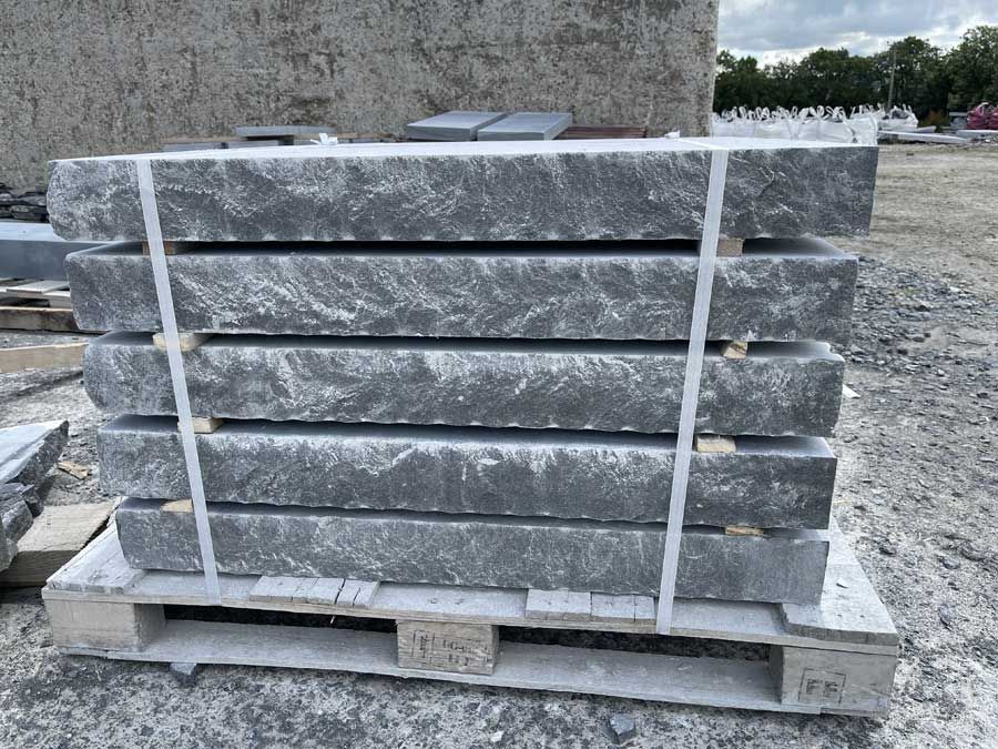 Hand dressed limestone rock faced pier caps ready for delivery