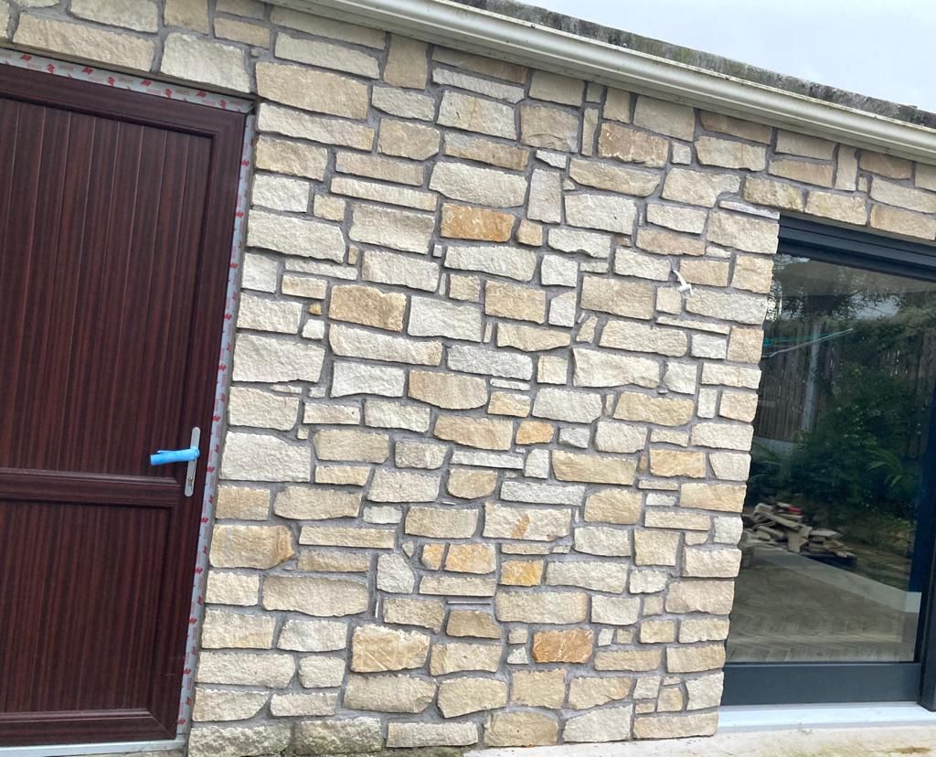 Cream sandstone thin stone cladding enhanced using a grey pointed joint