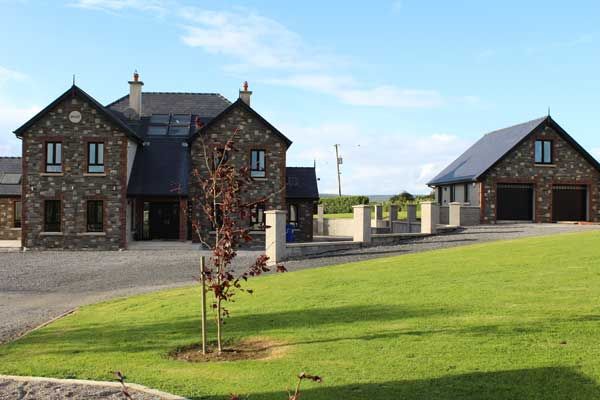 Mixed sandstone house front & garage