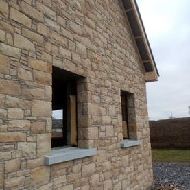 Dressed cream sandstone enhanced with sanded Irish limestone window cills