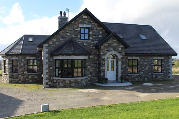 Mixed sandstone enhanced with granite corners and door surround