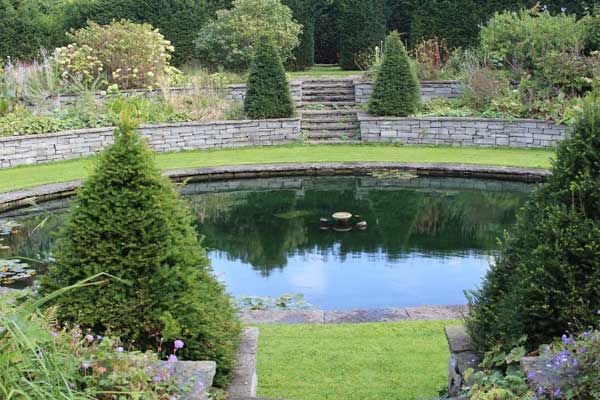 Sucken garden pond complimented with two tiered sandstone retaining wall