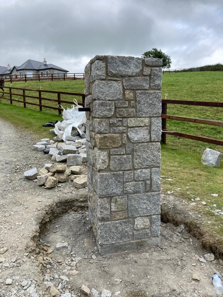 Grey granite pier with large dressed corner stones 