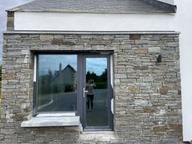 Brown sandstone gable capped with Irish limestone parapet wall capping