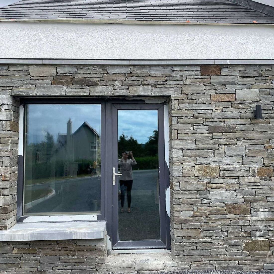 Brown sandstone gable capped with Irish limestone parapet wall capping