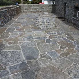 Random grey brown paving with a selection of grey brown walling