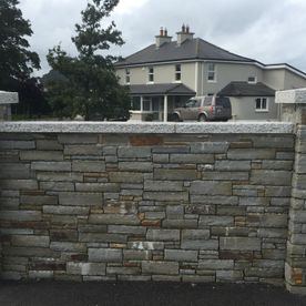 Grey sandstone complmented with granite wall capping