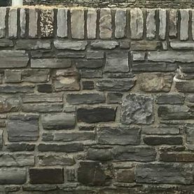 Dressed grey sandstone with brick surround