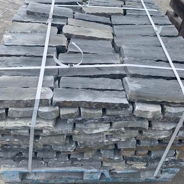 Grey sandstone cladding palletised and ready for dispatch