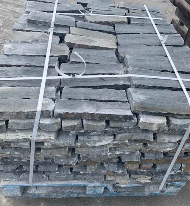 Grey sandstone cladding palletised and ready for dispatch