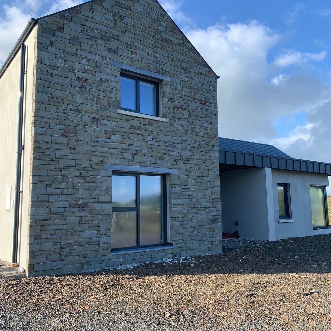 Grey sandstone complimented with sanded limestone heads & cills