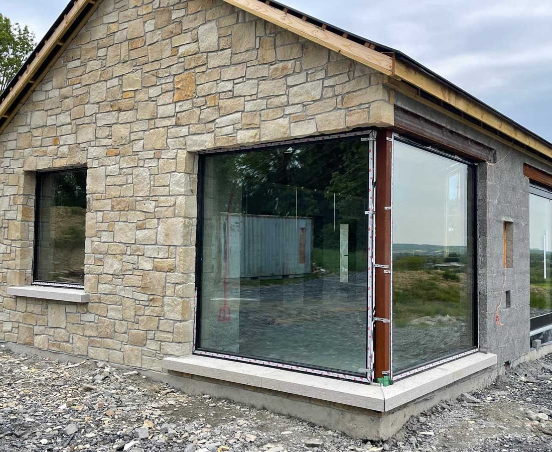 Cream sandstone framing a large corner window