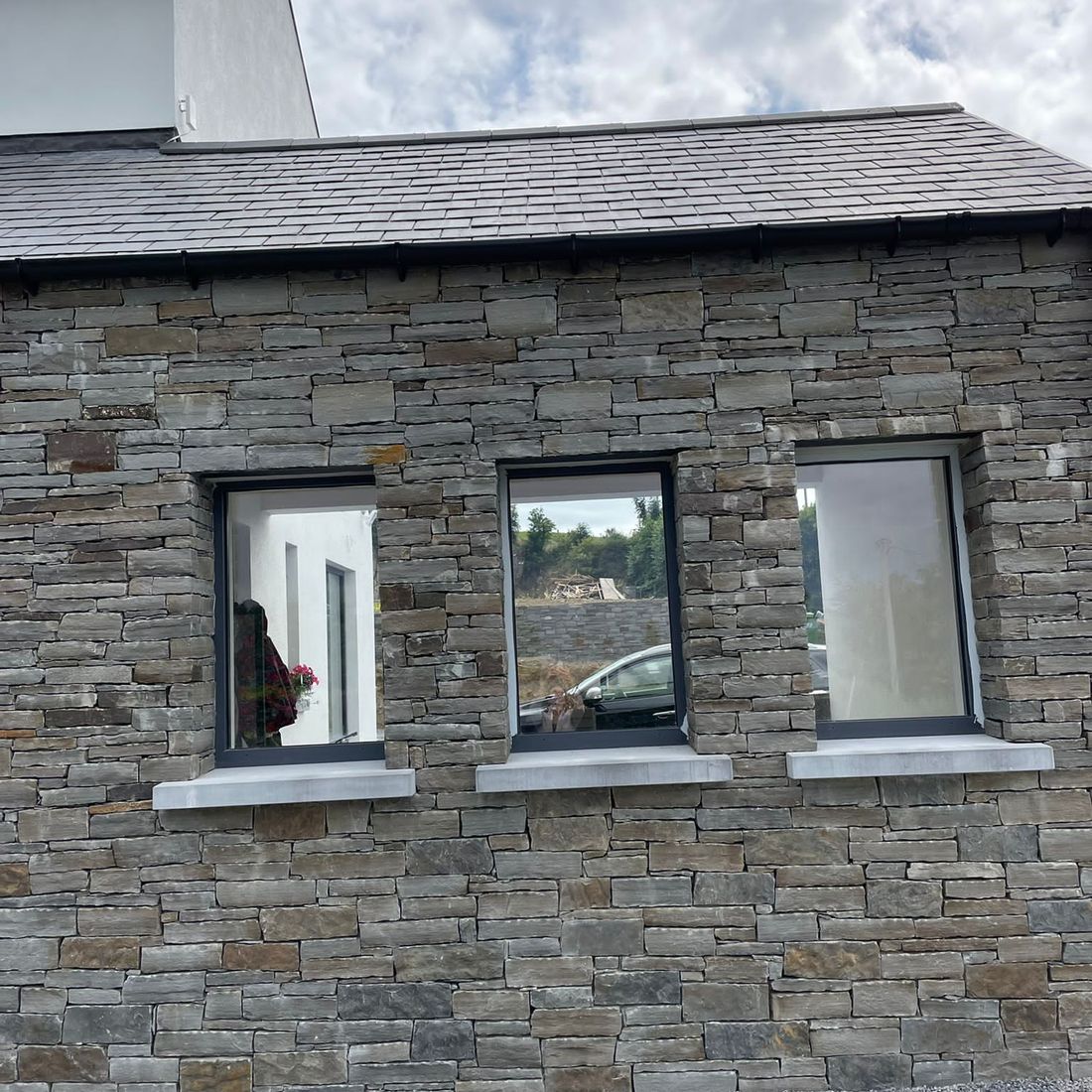 Traditionally laid grey sandstone with Irish limestone cills