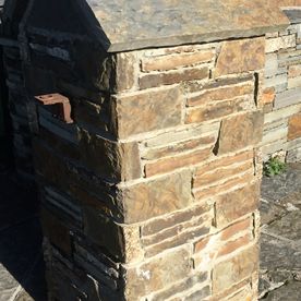 Split brown sandstone enhanced by grey sandstone paving