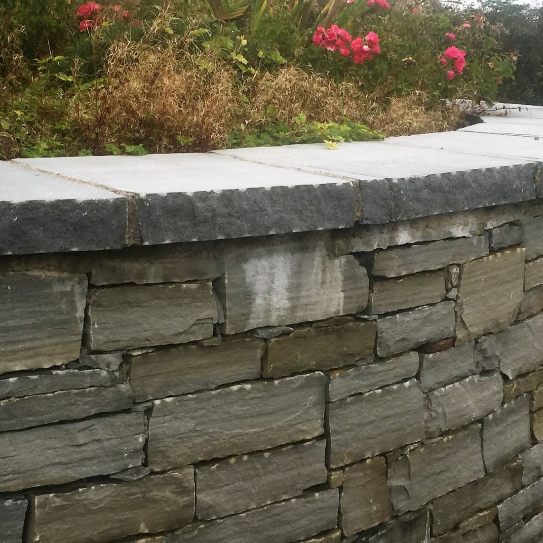 Limestone pitched face capping on curved wall